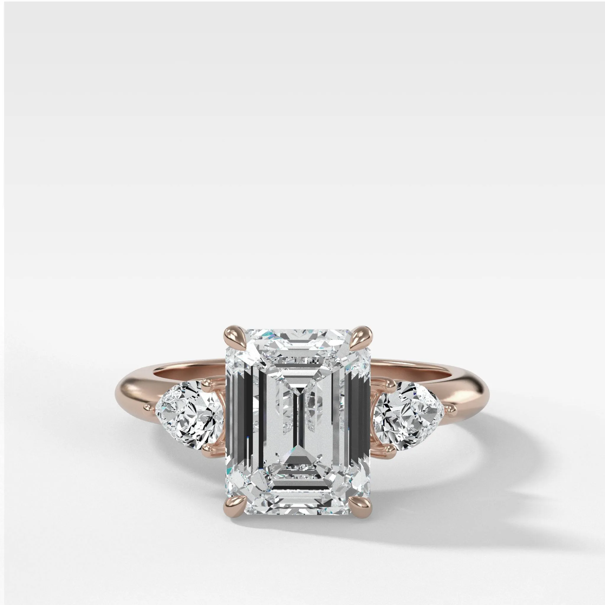 Three Stone Engagement Ring With Pear Side Stones and Emerald Cut Diamond