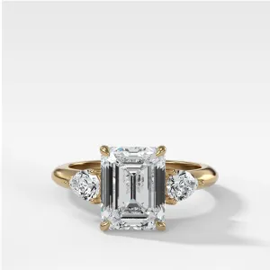 Three Stone Engagement Ring With Pear Side Stones and Emerald Cut Diamond
