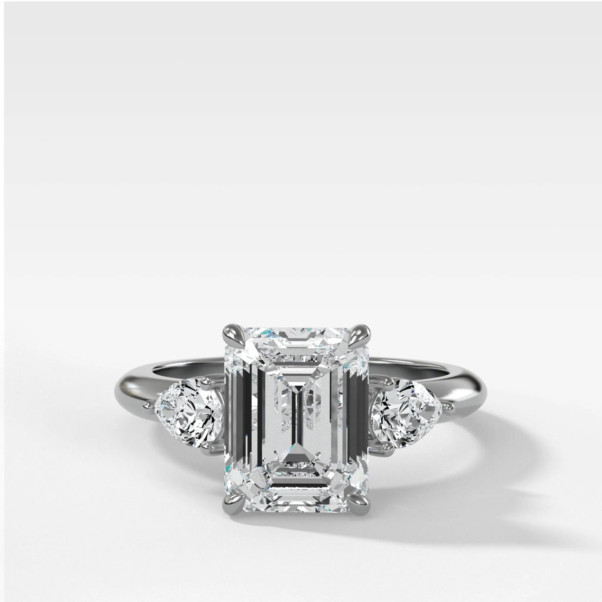 Three Stone Engagement Ring With Pear Side Stones and Emerald Cut Diamond